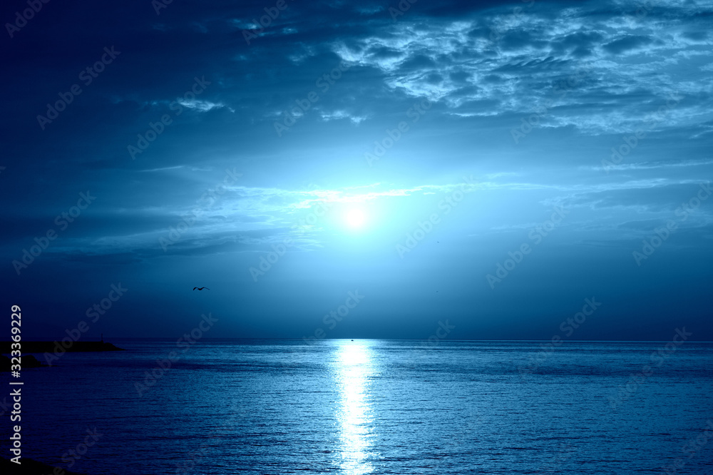 Sunrise over the sea near the coast of Sicily, Italy. Natural bakground blue color toned