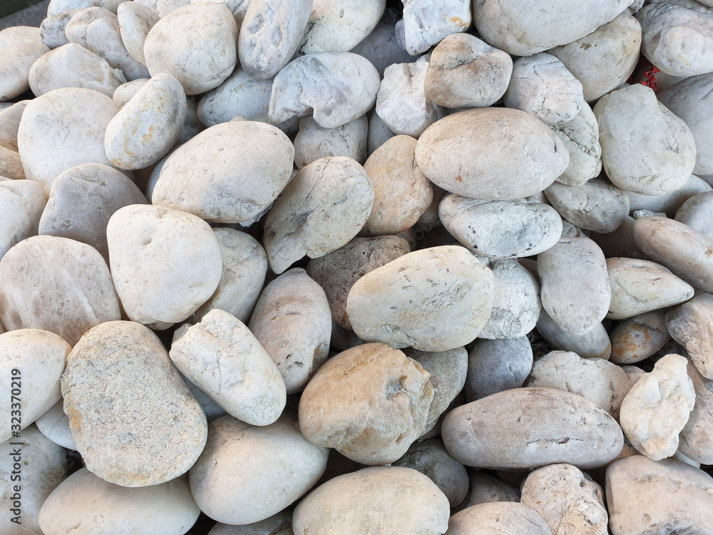 pebbles stone with Blue grass flowers texture and background pebbles stone with Blue grass flowers texture and background