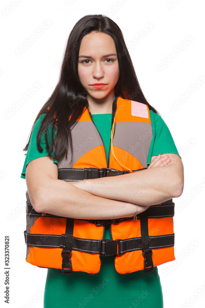 girl in orange life jacket with arms crossed, strict instructor or lifeguard, safety concept, on white background