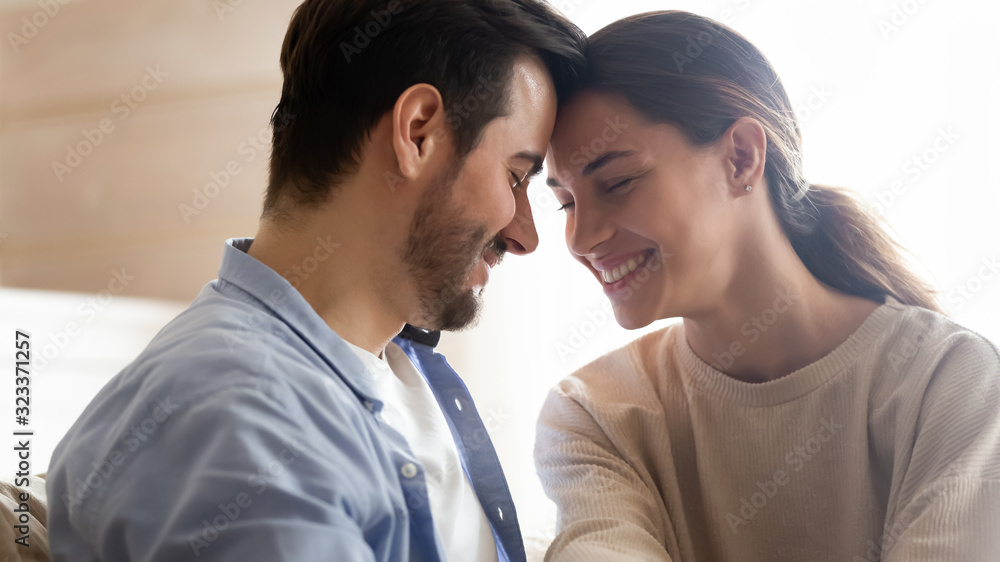 Happy young couple hug enjoying romance at home Happy young couple hug enjoying romance at home