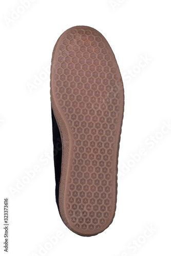 Beige grooved sole of shoes on a white background.