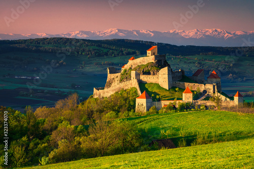 Picturesque medieval Rupea fortress at sunrise, Brasov region, Transylvania, Romania