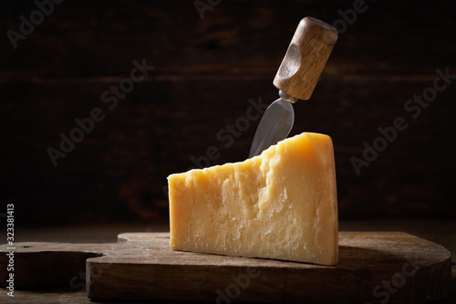 piece of parmesan cheese on a wooden background