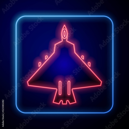 Glowing neon Jet fighter icon isolated on blue background. Military aircraft.  Vector Illustration