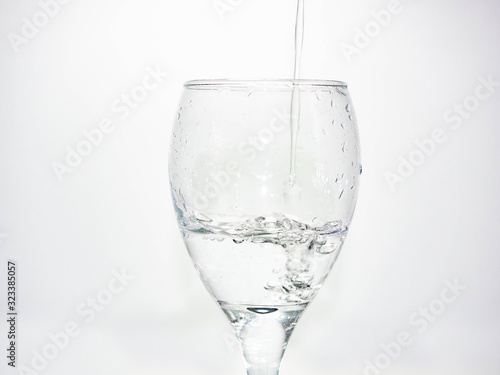 Pour water into the glass until small bubbles of various shapes are formed. White background