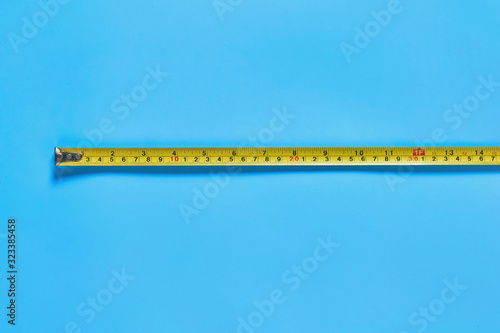 Ruler for measuring on blue desk in workshop. Space for text. Top view