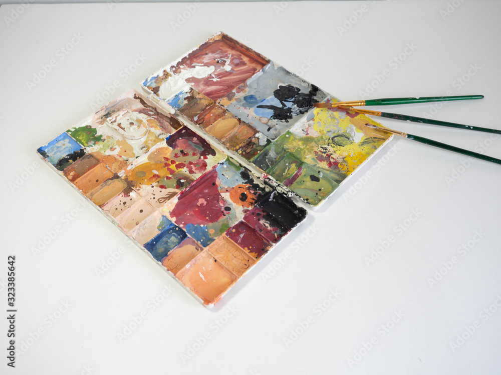 Color palette and brush,There are stains of many colors,White background for art work Color palette and brush,There are stains of many colors,White background for art work