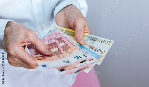 Female woman hand holds out a pack of euro close up, finance business concept.