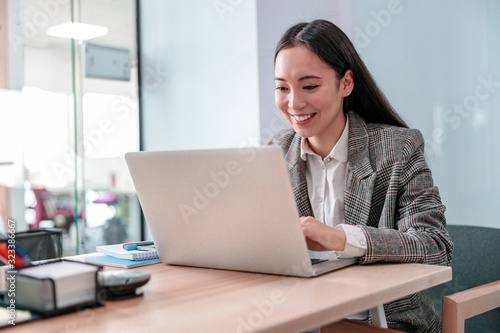 Asian young woman is woking in office