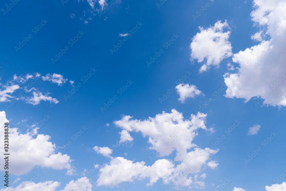 The blue sky with moving white clouds. The most of clouds are beautiful color and shade, suitable for use as background image.