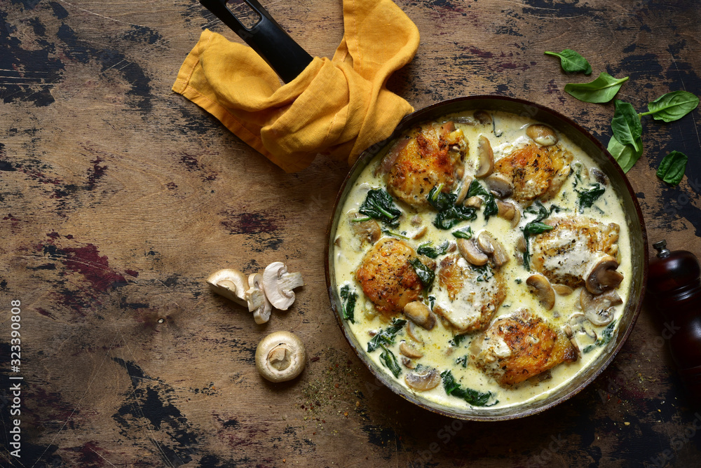 Chicken thighs stewed with mushrooms and spinach in a cream sauce. Top