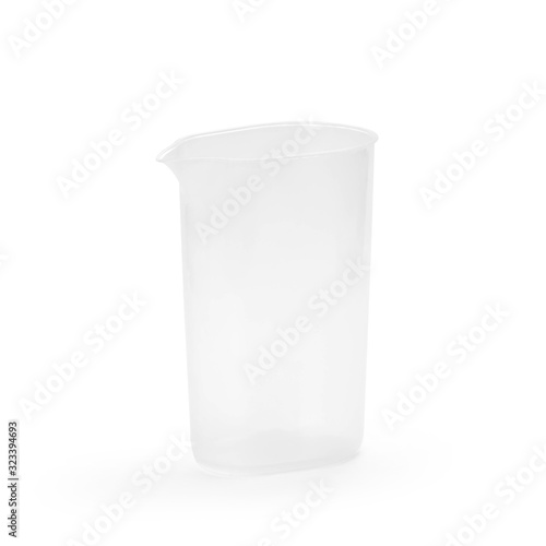 A small plastic cup with a spout. Close up. Isolated on a white background