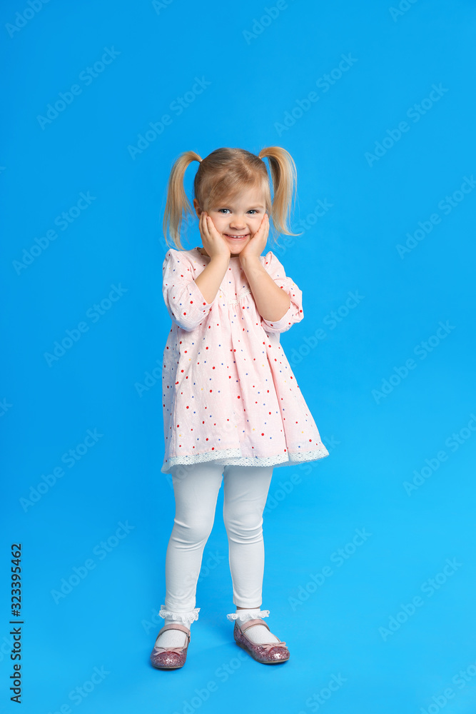 Portrait of cute little girl on blue background Portrait of cute little girl on blue background