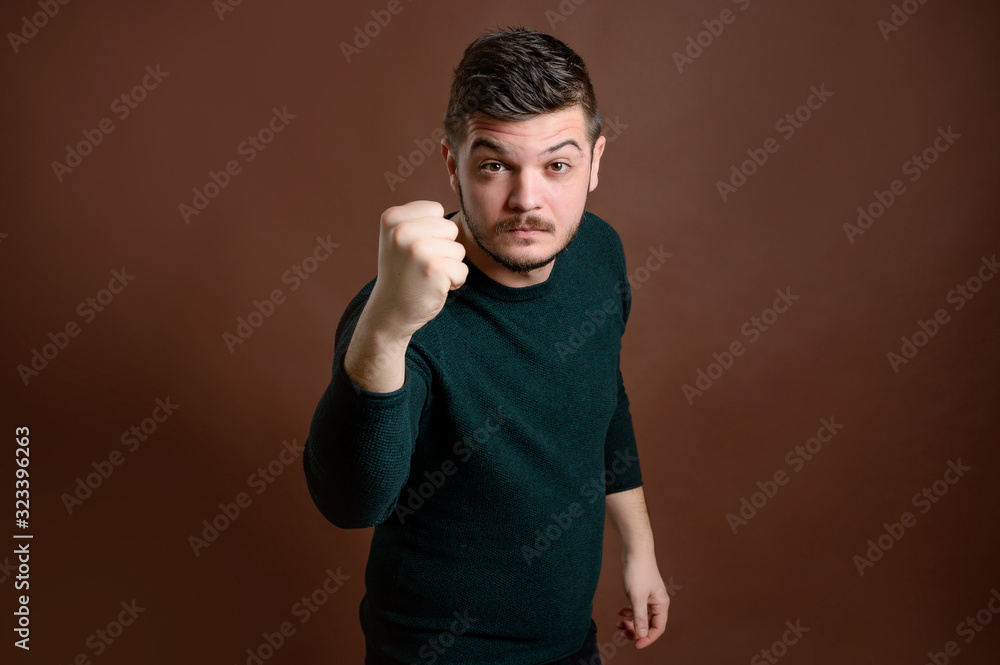 Naklejka premium Young man shows his fist