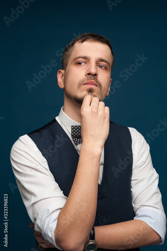 Pensive handsome young man in formal clothes