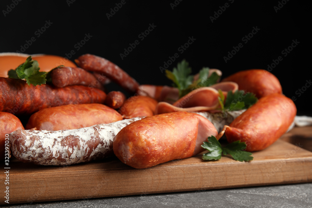 Different tasty sausages on wooden board, closeup Different tasty sausages on wooden board, closeup