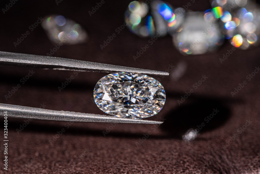 Diamond in Tweezers Close up Diamond in Tweezers Close up