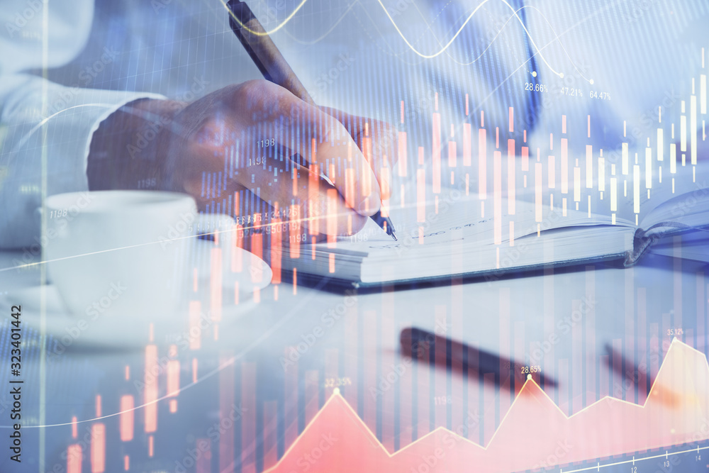 Double exposure of man's hands writing notes of stock market with forex chart. Double exposure of man's hands writing notes of stock market with forex chart.