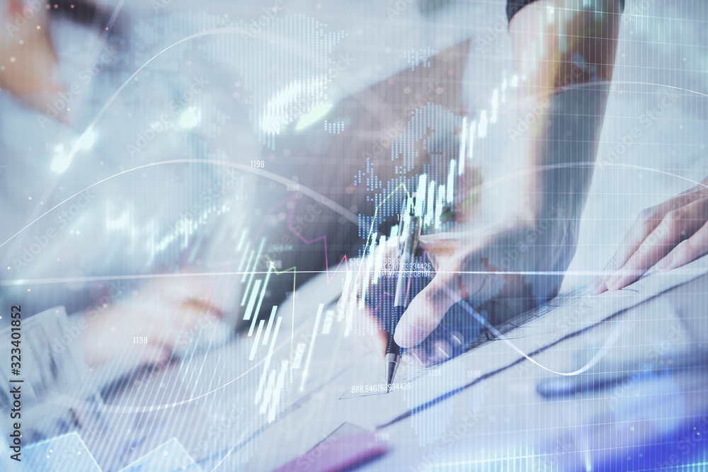 A woman hands writing information about stock market in notepad. Forex chart holograms in front. Concept of research. Double exposure A woman hands writing information about stock market in notepad. Forex chart holograms in front. Concept of research. Double exposure