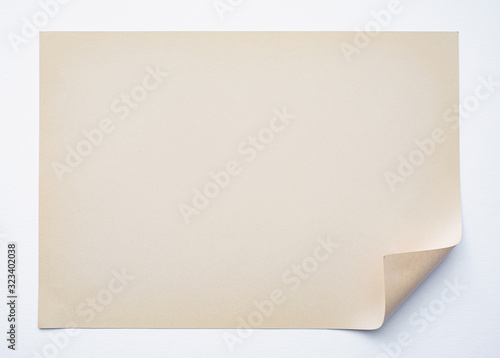 Retro Beige Blank Sheet of Paper with Folded Corner on Empty White Background