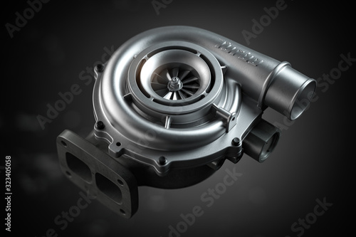 Car turbocharger on black background. Auto part turbo engine technology concept. photo