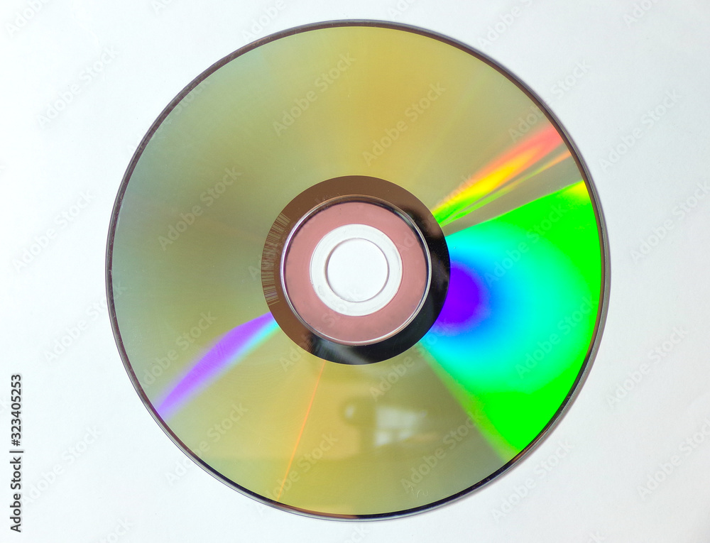 DVD CD is isolated on a white background. Iridescent disk in close-up. DVD CD is isolated on a white background. Iridescent disk in close-up.