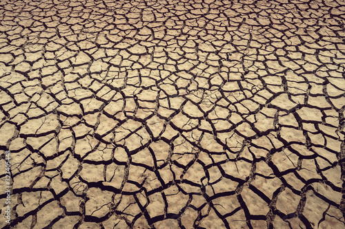 cracked earth from arid drought weather in dam or river, hot summer nature and warming climate environment
