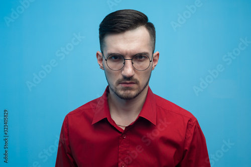 Young man in glasses and a burgundy shirt