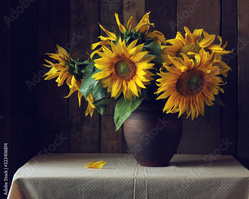 bouquet of sunflowers in a clay jug