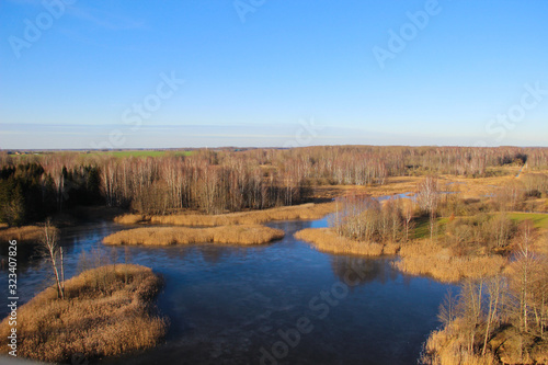 The National park with karst lakes and flooded old grass meadow in Kirkilai  Lithuania. Walk at the wetland reserve on a sunny winter day. 