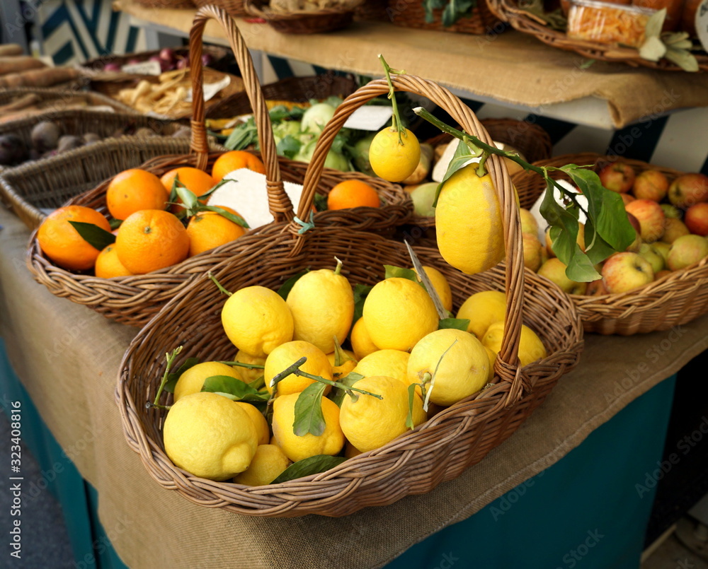 Organic lemons in a wicker basket on the table exposed to the local market on which it sells natural, organically grown fruits and vegetables