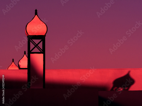 Quadro em tela Roof top architecture with onion domes are lit by a red sunset light and dramatic shadows are cast