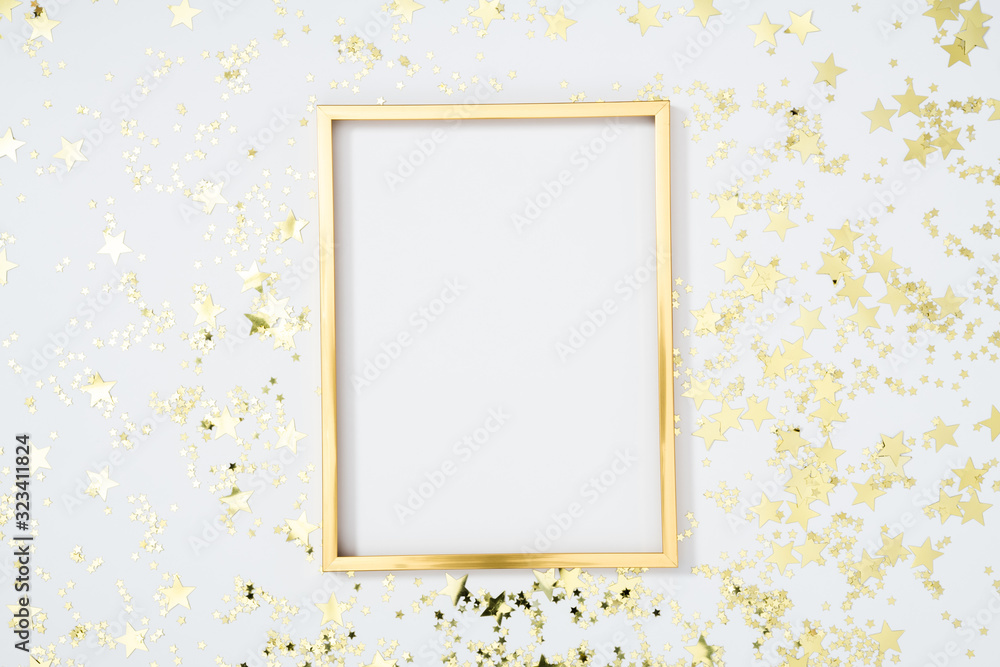 Gold frame with gold stars on white background. Flat lay, top view, copy space Gold frame with gold stars on white background. Flat lay, top view, copy space
