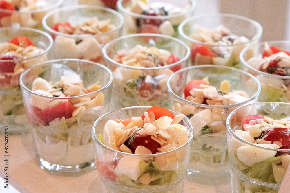 Vegetable appetizers in glasses on a banquet table. Treats for guests at celebration. Vegetable appetizers in glasses on a banquet table. Treats for guests at celebration.