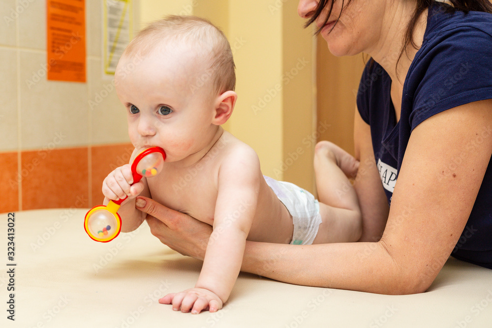 Pediatric Physical Therapy - an infant exercising on a table Pediatric Physical Therapy - an infant exercising on a table