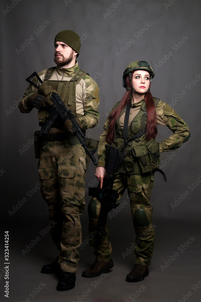 Twol soldiers in camouflage clothing poses in a Studio Twol soldiers in camouflage clothing poses in a Studio