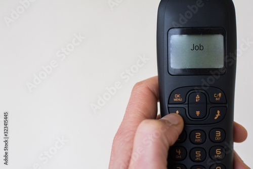 Wallpaper Mural Wide view of a male hand receiving a phone call from work. Torontodigital.ca
