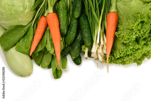 Fresh green vegetables and herbs isolated on white background. Space for text or design.