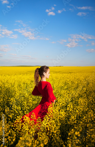 girl in a beautiful red dress is standing in a yellow box © Artsaba Family