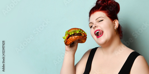 Wallpaper Mural Happy size-plus overweight fat woman happy hold burger cheeseburger barbeque sandwich with beef  on pastel turquoise Torontodigital.ca