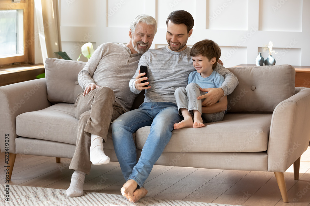 Joyful intergenerational male family taking selfie at home. Joyful intergenerational male family taking selfie at home.