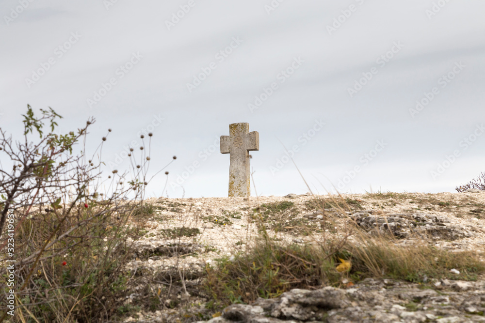 Fototapeta premium Stone Cross and six-pointed Lotus.