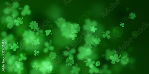 Background on St. Patrick's Day made of blurry clover leaves in green colors