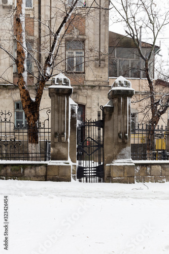 Stone fence with spikes is located on the vertical image.