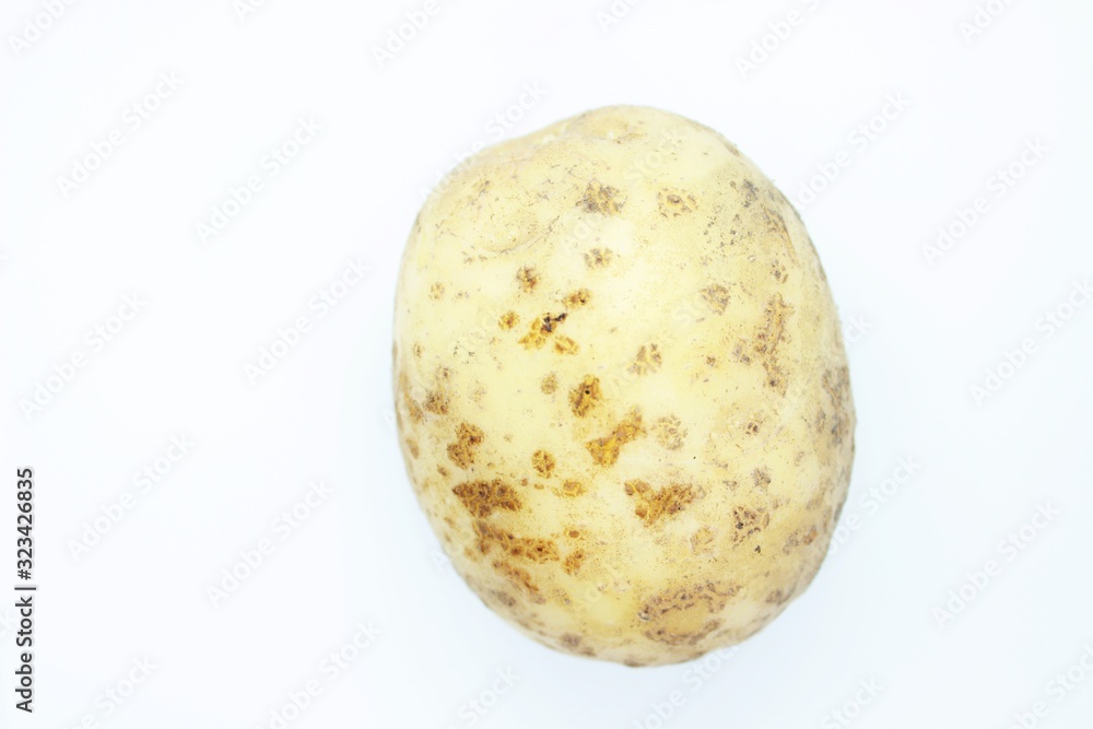 Unpeeled potatoes perched on a white background Unpeeled potatoes perched on a white background