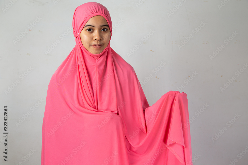 Muslim women standing prepare to wear a hijab in the mosque for prayer, in the month of Ramadan Muslim religion Islamic worshiping god faith and learn koran Muslim women standing prepare to wear a hijab in the mosque for prayer, in the month of Ramadan Muslim religion Islamic worshiping god faith and learn koran