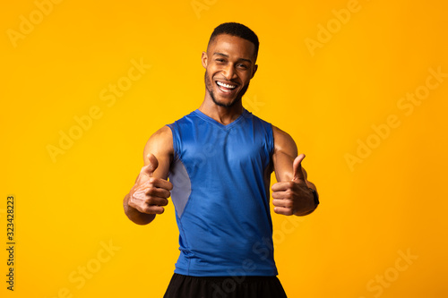 Afro sportsman showing thumbs up looking at camera