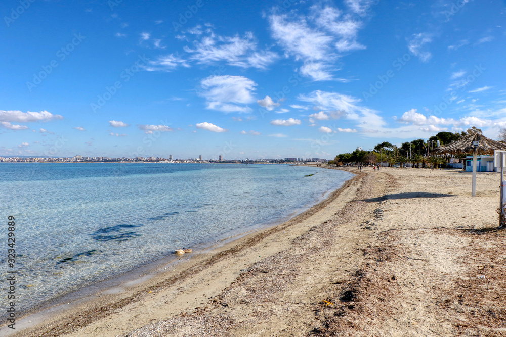 Beach on a sunny day in the middle of winter in Taranto, Puglia, Italy