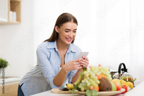 Woman searching new recipe online on phone