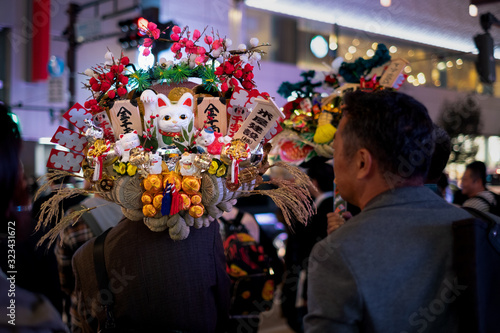 Japanese man in the crowd carrying colorful good fortune 